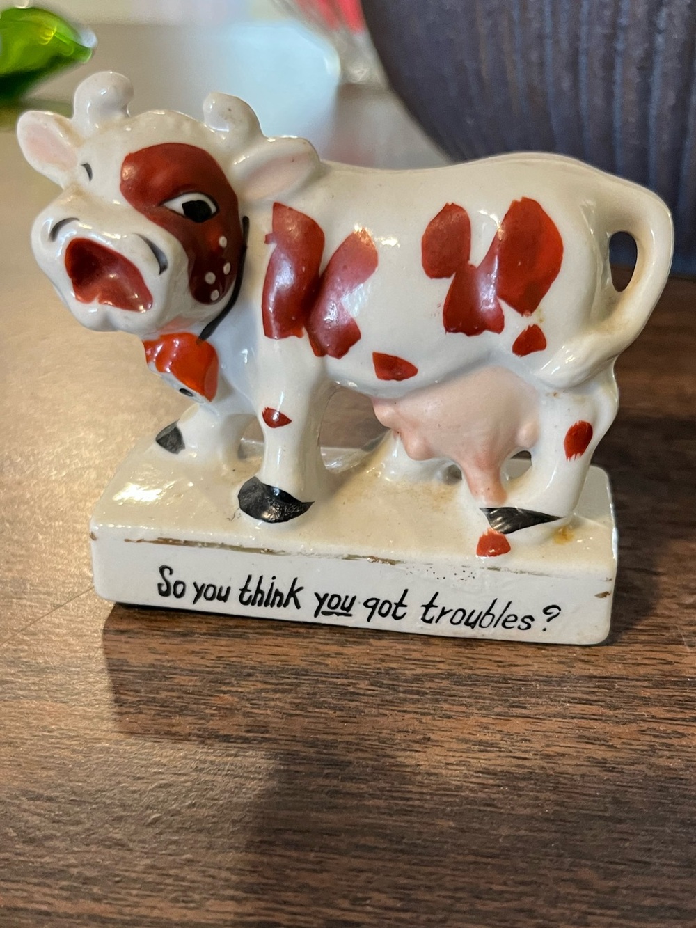 White and Red Ceramic Cow Figurine with Humorous Script